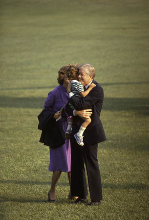 Washington DC:
Pres. and Mrs Carter are greeted by their grandchild on the South Lawn.