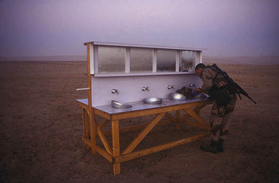 Saudi Arabia:
Member of the 1st cavalry prepares for morning watch.